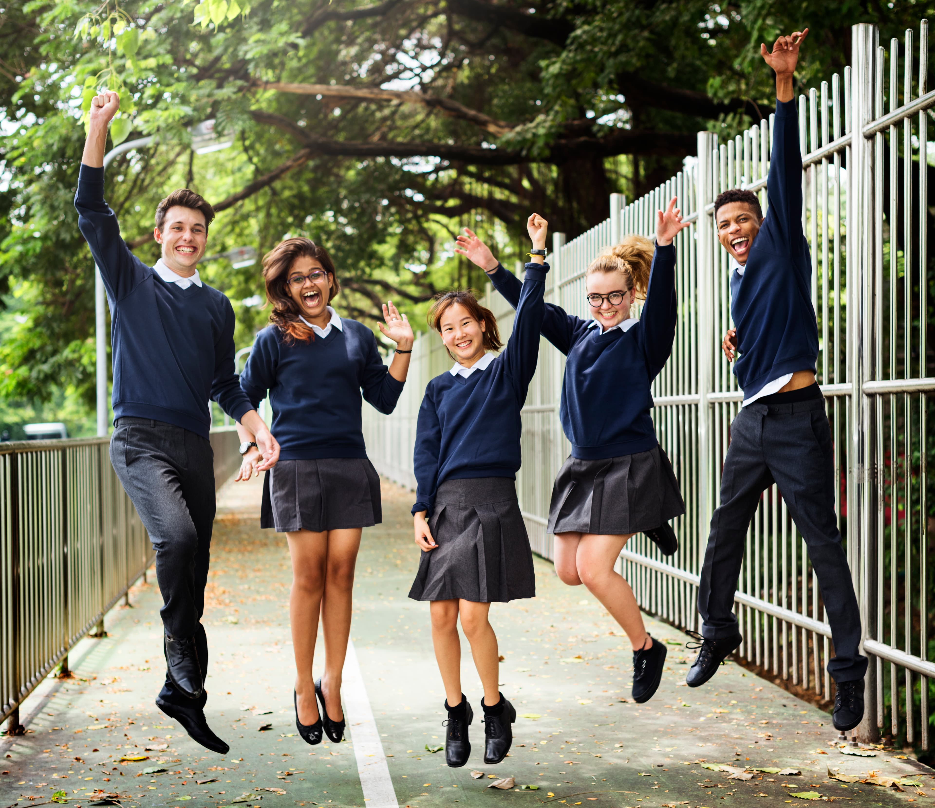 Students in school uniform jumping