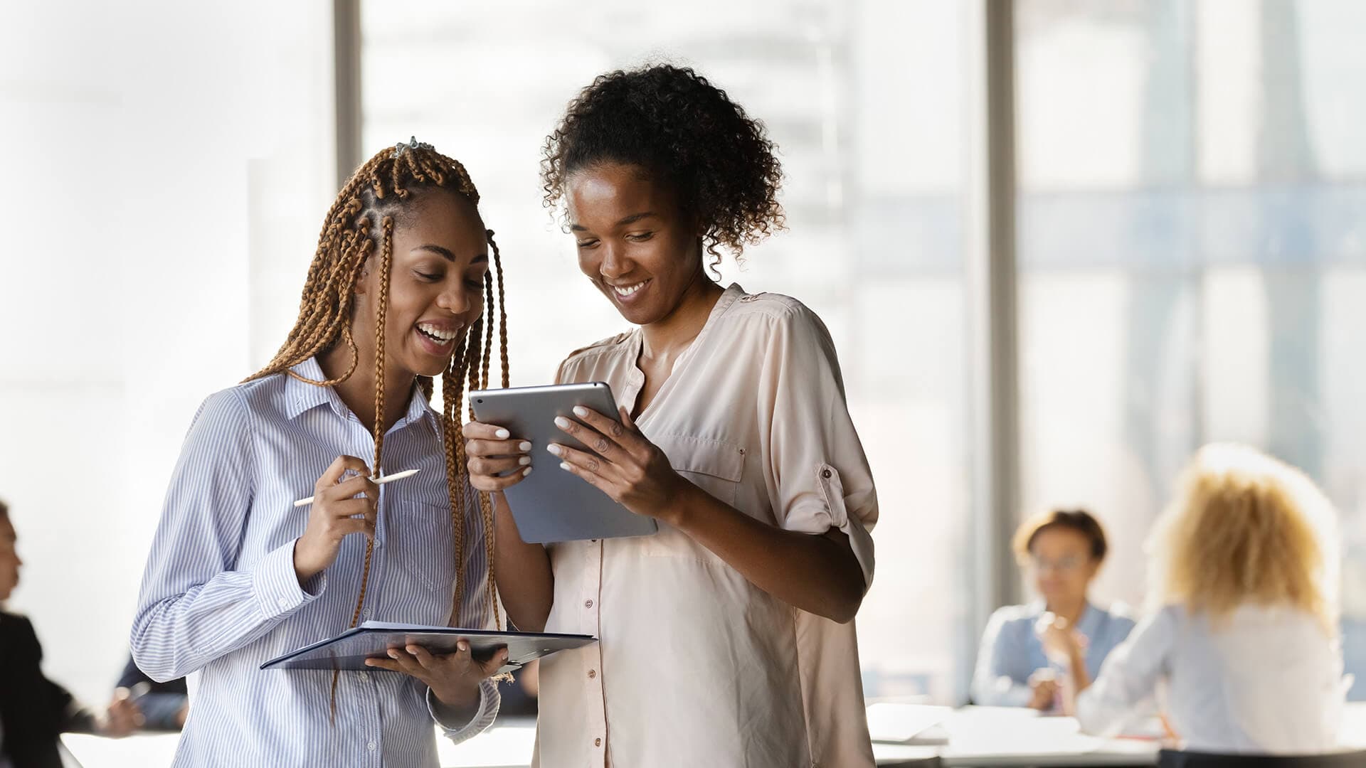 Two young people at apprenticeship, laughing.