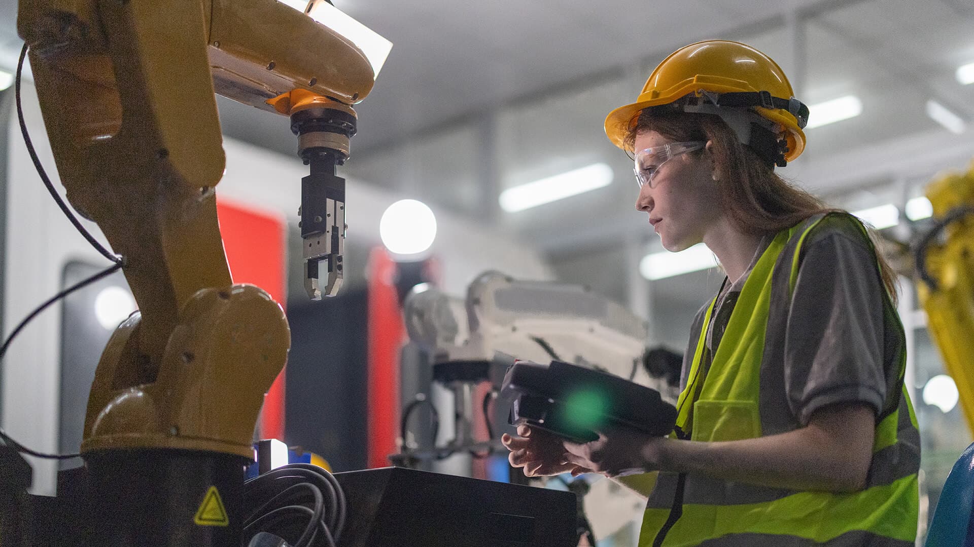 A girl uses some engineering machinery.
